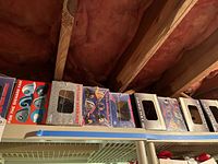 Shelf with 10 stadium style NFL hard hats in original boxes, each with visible team helmet designs and logos.