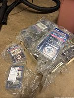 Various sealed 2-pack sets of MLB team magnets showing Seattle Mariners, Tampa Bay Rays, and others, all unopened in plastic bags.