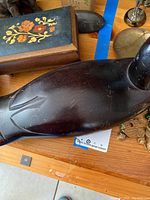 Large smooth black carved bird figurine possibly a decoy