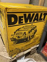 Front of yellow box with large DEWALT logo and illustration of the planer