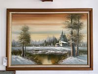 Full view of framed oil painting showing winter landscape with pond, trees, barn, and signature.