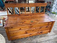 Front view of pine wood storage bench showing hinged top seat and solid wood construction.