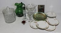 Full lot overview showing all glassware, plates, candlesticks, and small package included.