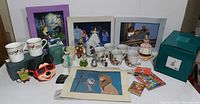Overview photo of entire lot showing mugs, figurines, pins, prints, and boxes on white background