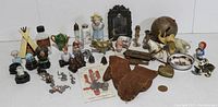 Overview photo of all miniature collectibles and antique mittens arranged on a white surface.