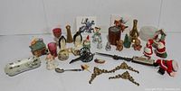 Diverse assortment of vintage small collectibles including ceramic figurines, miniature bottles, decorative miniature items, and Christmas theme decorations.