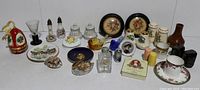 Full lot view showing diverse miniatures and collectibles including framed art, ceramics, glass birds, and salt and pepper shakers.