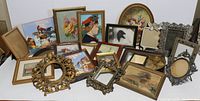 Overview of lot with multiple framed artwork pieces and various ornate vintage cast metal and decorative frames, arranged on a surface.