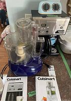 Food processor and coffee maker with manuals and timer on kitchen counter