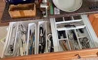 Wide shot of drawer with cutlery, utensils and STAR meat grinder on countertop