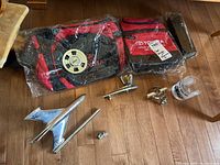 Photo including Toyota branded lunch bags, chrome car hood ornaments and emblems arranged on floor
