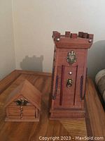 Castle-shaped wooden shot glasses holder/tower with battlements and metal accents.