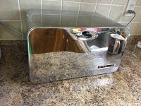 Front view of the chrome retro bread drawer on countertop with black knob and 'BREAD' label.