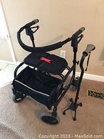 Nexus rollator walker in black with padded seat, handlebar grips, and under-seat storage pouch.