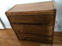 Full frontal view of the waterfall dresser showing three drawers and rounded edges