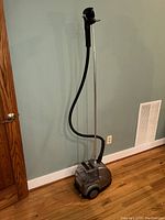 Full view of the clothing steamer unit including the base, hose, steamer head, and telescopic stand.