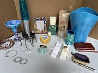 Photo showing the full assortment of gifts and sundry items including goblet, lava lamp, frames, candleholders, bracelets, candles, and others