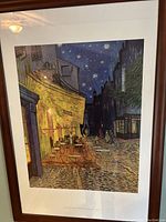 Impressionist street scene print in brown wooden frame showing outdoor cafe at night with starry sky