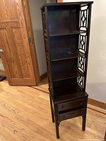 Front view of full etagere showing all four shelves, drawers and overall structure on hardwood floor