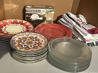 Photo showing all plate sets and tea towels together to depict quantity and condition