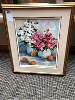 Full view of framed oil painting depicting white daisies and pink mums in vases with pears on table, signed by artist at bottom right.