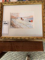 Full view of the framed watercolor painting showing the entire artwork and ornate gold frame.