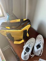 White Dexter Slide Rite women's bowling shoes size 8 next to the black and yellow bowling bag