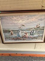 Full view of framed oil canvas painting depicting an outdoor scene with figures and buildings near water.