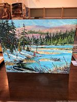 Full view of the oil painting depicting a lakeside landscape with trees and hills in the background