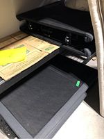 Two black fabric-covered adjustable bed frames stacked under mattresses