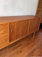 Front left angle showing drawers and sliding doors