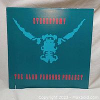 Front cover of Sterotomy vinyl LP album by The Alan Parsons Project showing stylized graphic and red text on teal background.