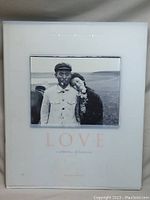 Front cover of the book showing the title 'LOVE a celebration of humanity' with a black and white image of an Asian man and woman.