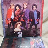 Front cover of the Heart Self Titled vinyl album featuring the band members in colorful 90s attire along with the album title and band name.