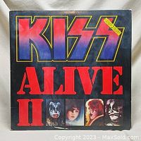 Front cover of Kiss Alive II vinyl album showing title and band member portraits.