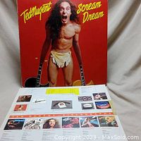 Front cover of Ted Nugent's 'Scream Dream' vinyl album with image of Ted Nugent holding guitars and discography insert below.