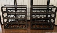 Front view of two empty dark espresso floor wine racks side by side showing 4 rows of horizontal bottle holders per rack.