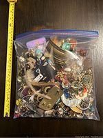 Large freezer bag filled with assorted costume jewelry items in various styles and materials.