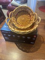 Two large wooden woven baskets nested one inside the other showing their size and construction