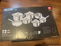 Front of boxed Zwilling Joy set showing 12 pcs graphic and pot lineup