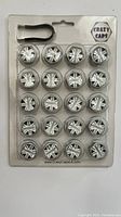 Front view of unopened Crazy Caps car wheel bolt cover set, showing 20 silver bolt covers and installation hook on original backing card.