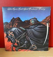 Front album cover with fantasy artwork of cloaked skeletal figure on horse in desert.
