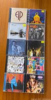 Front covers of 10 rock, alternative, and jazz CDs in jewel cases showing varied album artwork and artists.