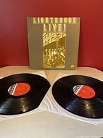Front of Lighthouse Live album showing gatefold cover front with sepia-tone photo and gold lettering