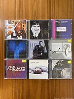 Top side of nine mixed CDs featuring easy listening and jazz music, showing front cover artwork and titles.