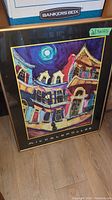 Framed colorful Michalopoulos poster with buildings and moonlit sky