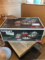 Cuisinart 10 piece cookware set boxed with photo of various pots and pans with lid in red stainless steel finish.