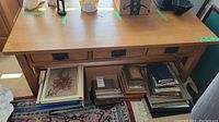 Top view of oak coffee table showing three drawers and various items placed on top (not included).