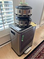 Full view of the stainless steel foot pedal garbage bin with the 24-slot spice rack placed on top.