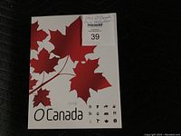 Closed presentation box cover with O Canada artwork